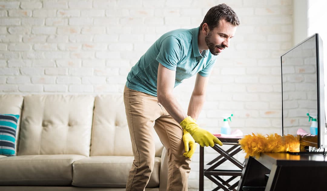 Young man dusting